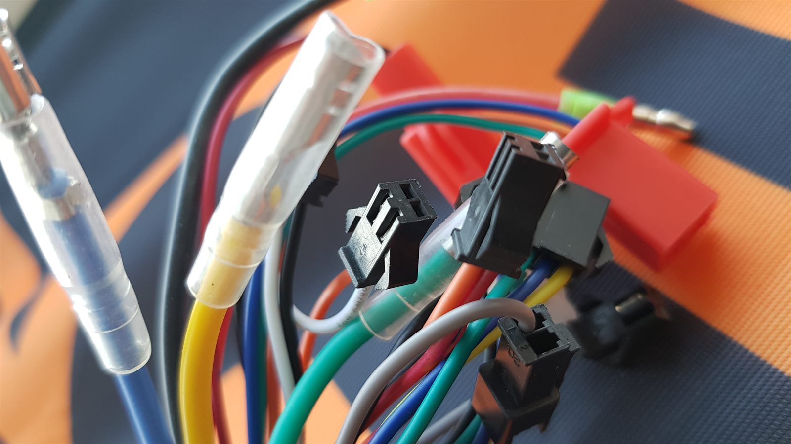 Colourful e-bike wiring harness and connectors during a repair