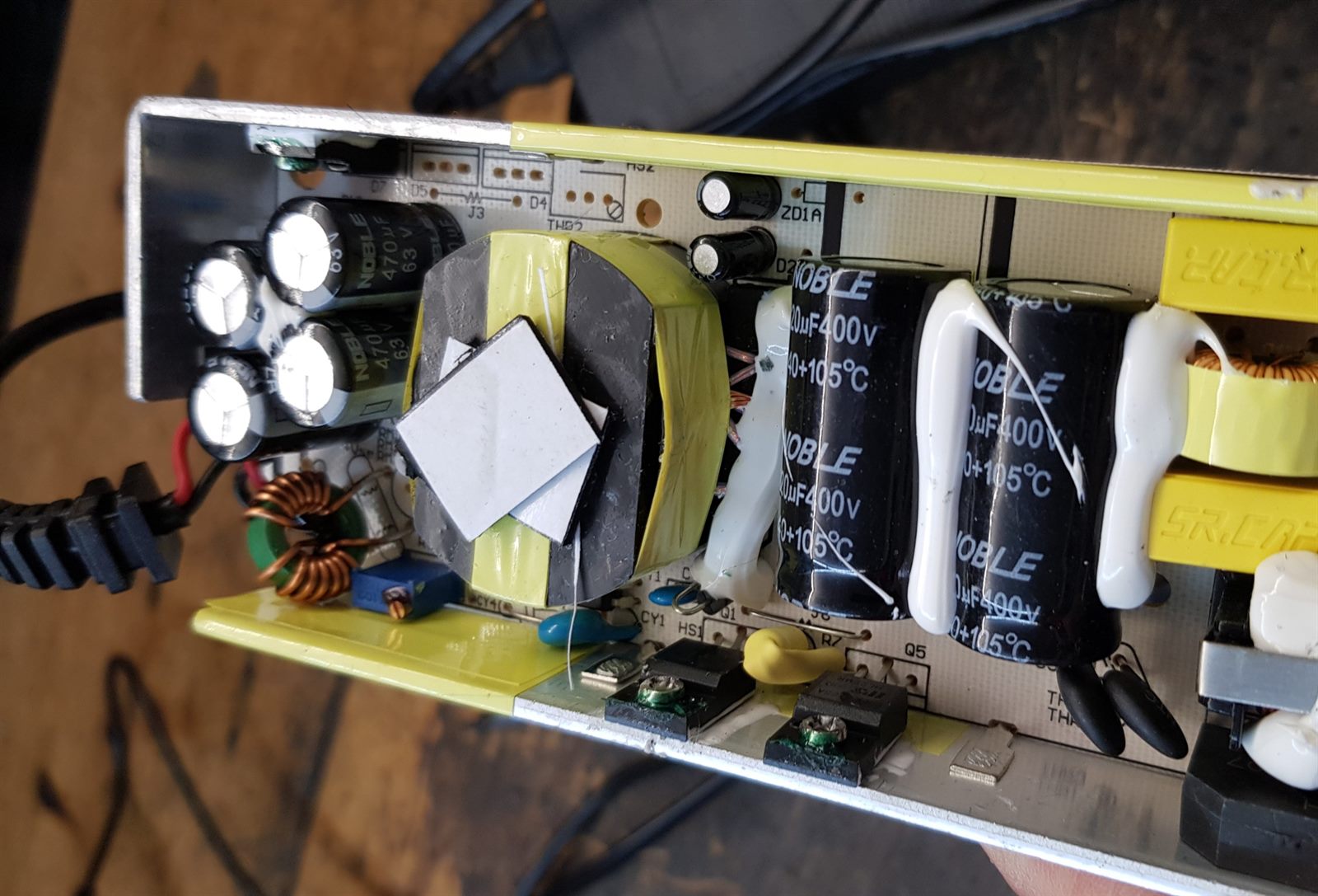 Open charger circuit board being repaired at the bench